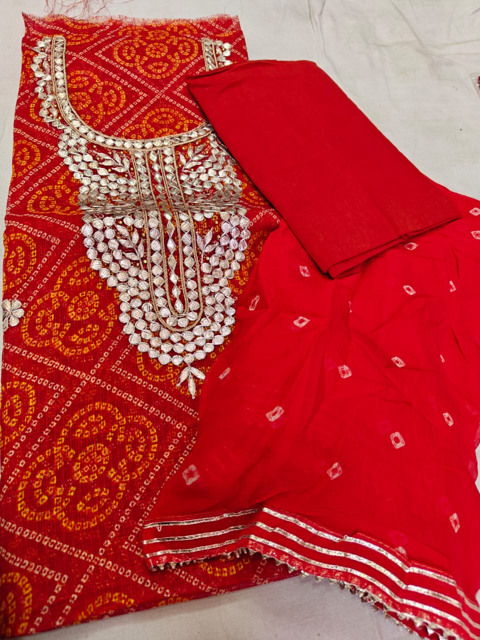 Festive Red Bandhani Semi Silk Dress Material with Heavy Gota Patti Hand Work, Chiffon Dupatta & Cotton Bottom – 3 Piece Unstitched Suit Set