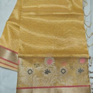 Elegant handcrafted Kota Tissue saree featuring a shimmering golden weave, intricate floral handwoven border, and a matching running blouse piece.